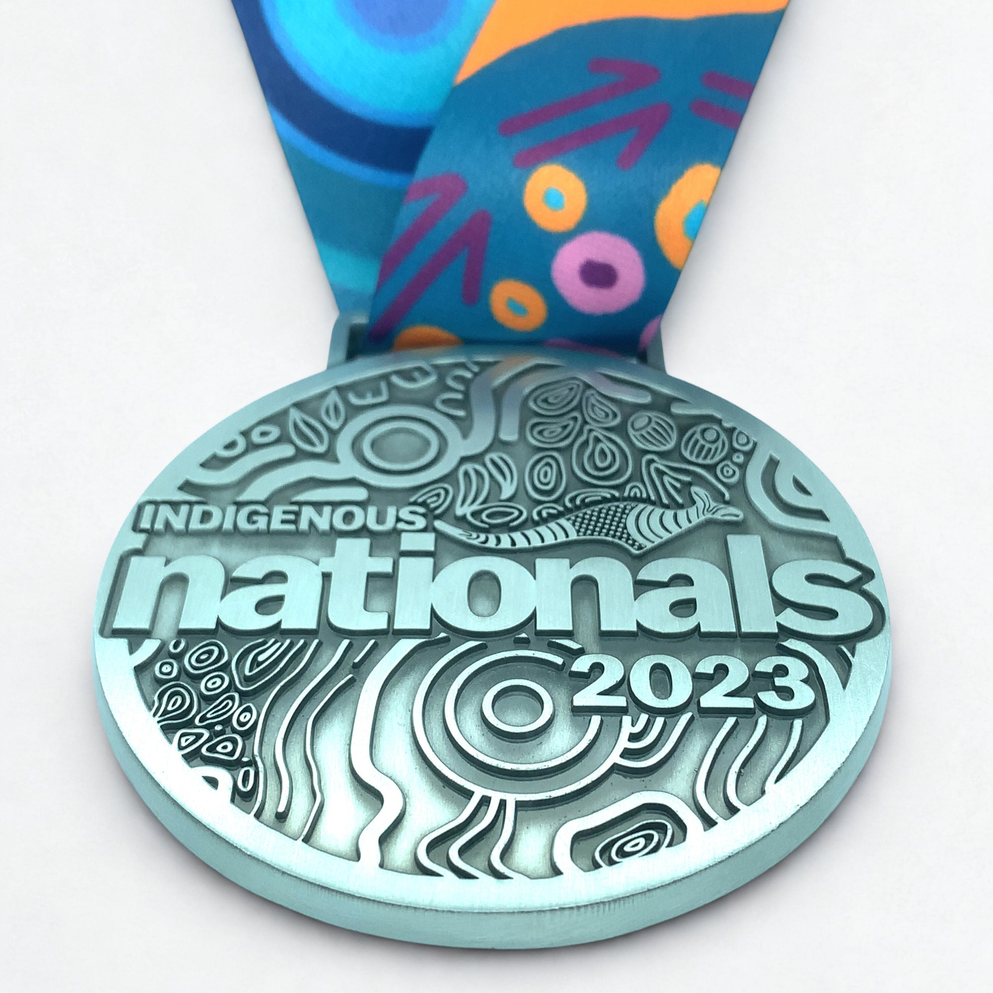 Medal with 'Indigenous Nationals 2023' text on a white background